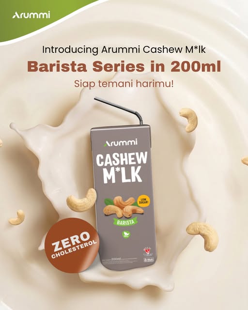 Arummi Barista carton, grey-taupe with a green Barista label, on a splash of milk with cashews.
